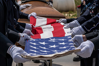 Members of the military properly fold the U.S. flag.